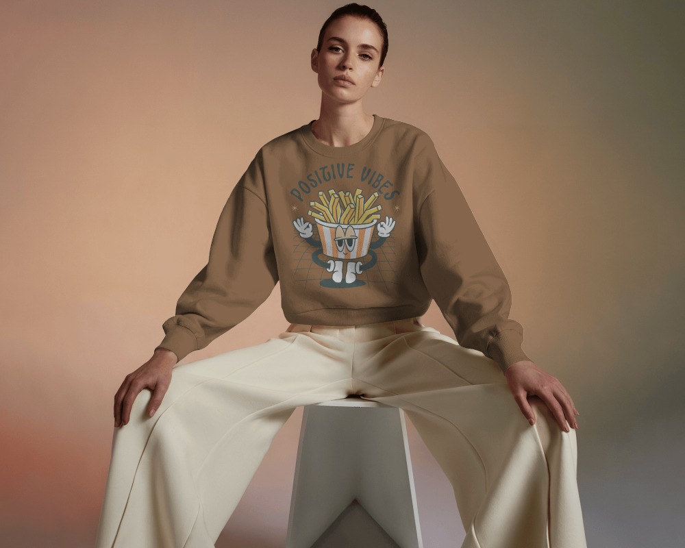 Neutral Tone Sweatshirt Mockup Female Model Sitting With Wide Pose On Minimalist Background