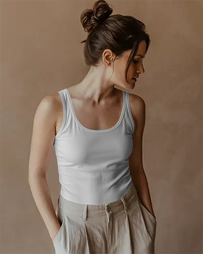 soft-shadowed-tanktop-mockup-with-woman-facing-left-wearing-white-top-and-high-waisted-trousers