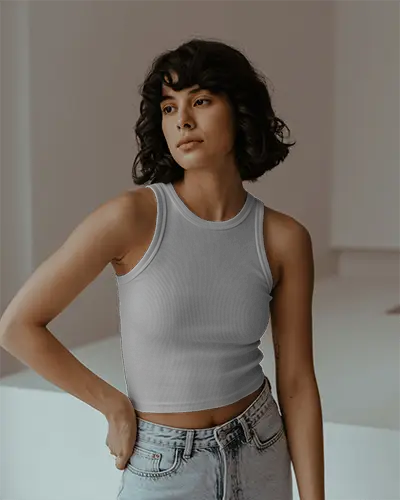 Minimalist Indoor Tank Top Mockup Female Model Looking Away In Soft Light With Modern Backdrop 069