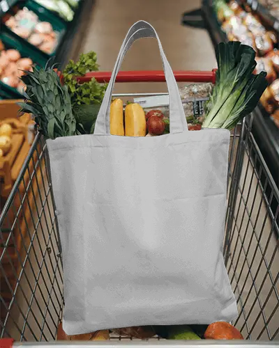 Eco Friendly Grocery Totebag Mockup White Canvas Bag With Your Design Here Placeholder Filled With Fresh Produce And Placed In A Shopping Cart