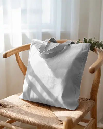 Sunlit Interior Tote Bag Mockup White Fabric Bag On Wooden Chair With Curtain Backdrop 0287
