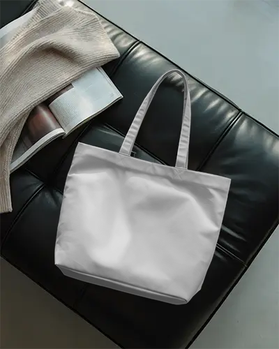 Relaxed Interior Tote Bag Mockup On Black Leather Seat With Open Magazine And Knitted Blanket 0294