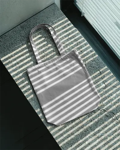 Minimalistic Canvas Tote Bag Laying On Textured Surface With Natural Light Patterns 0305
