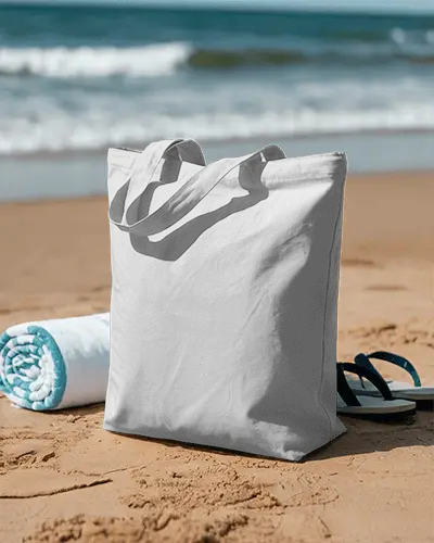 Reusable Cotton Tote Bag Mockup On Sandy Beach With Rolled Towel And Flip Flops Visible 0346