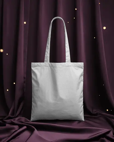 tote-bag-mockup-against-rich-purple-drapes-with-soft-floating-light-particles