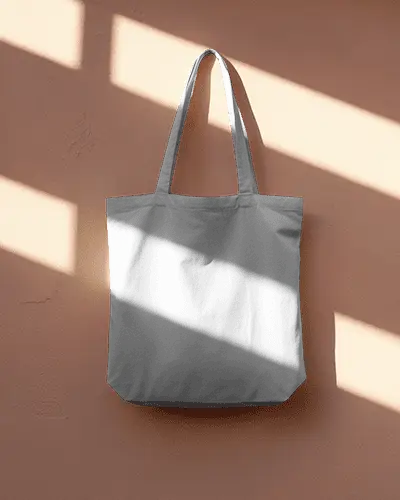 tote-bag-mockup-on-wooden-surface-with-angled-sunlight-creating-strong-contrast