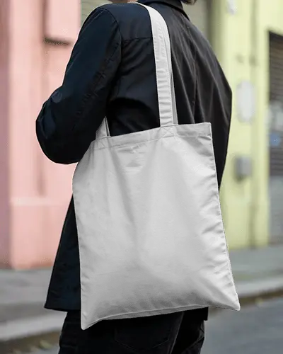 tote-bag-mockup-over-shoulder-on-street-with-colorful-building-background
