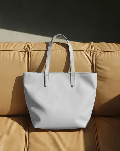 luxury-leather-style-tote-bag-mockup-on-modern-sofa-sunlit-living-space-classy-fashion-display