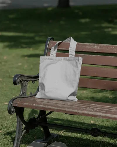 Durable Canvas Tote Bag Hanging On Wooden Bench For Personalized Print Designs