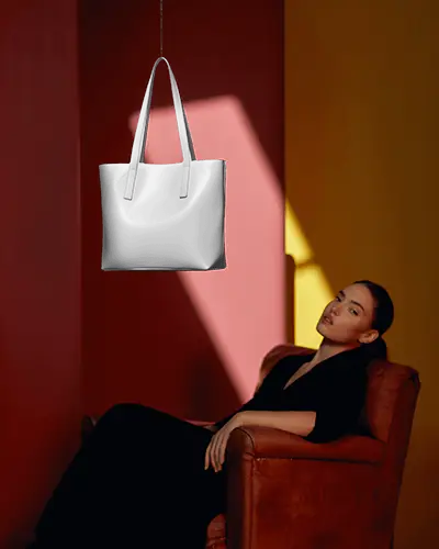 Minimal Artistic Tote Bag Mockup Floating Product With Model In Red And Yellow Room Contrast