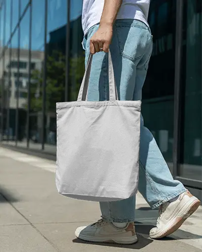 Casual Outdoor Tote Bag Mockup Male Model Walking In Denim Jeans Urban Street Daylight Scene