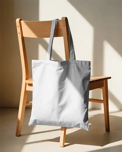 Cotton Tote Bag Mockup Draped Over Wooden Chair In Soft Natural Daylight Setting