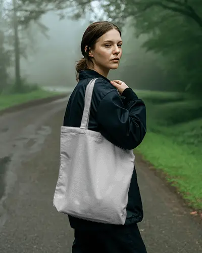 Misty Forest Tote Bag Mockup Woman Standing On Road In Moody Outdoor Setting