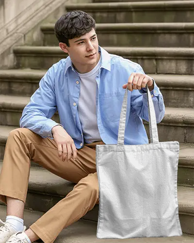 Casual Campus Tote Bag Mockup Man Sitting On Steps In Relaxed Outdoor Setting