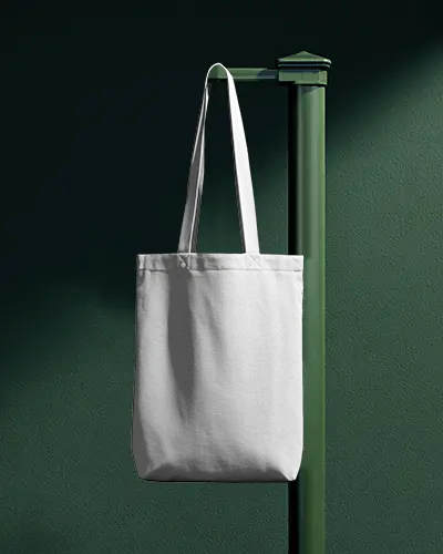 Vertical Post Totebag Mockup Hanging On Minimal Green Stand With Soft Directional Light