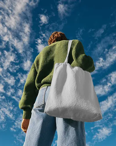 Low Angle Outdoor Totebag Mockup Back View Model Under Blue Sky With Natural Daylight