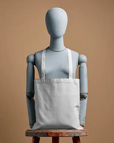 Vintage Mannequin Totebag Mockup Dark Canvas Bag On Rustic Wooden Stool Warm Neutral Backdrop