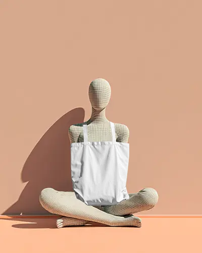 Seated Mannequin Totebag Mockup Canvas Bag On Textured Figure Soft Peach Studio Background