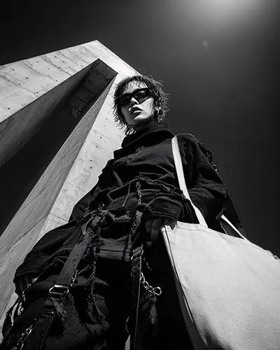 Edgy Streetwear Totebag Mockup Canvas Bag On Model Shot From Below Urban Brutalist Architecture