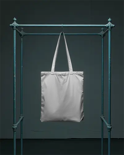 Eco Friendly Reusable Tote Bag Mockup Hanging For Branded Merchandise Presentation