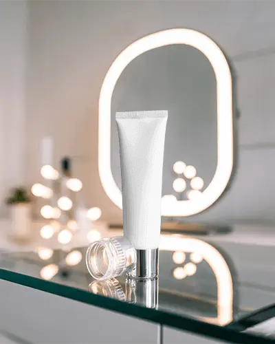 sleek-tube-mockup-on-reflective-surface-with-modern-vanity-mirror-background
