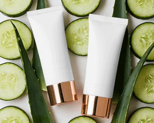 Natural Skincare Tube Mockup With Organic Cucumber And Aloe Vera Leaves Background