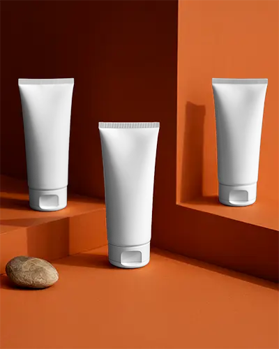 Sleek Skincare Tube Mockup Placed On Geometric Platform With Natural Stone Accessory Display