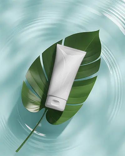 natural-themed-skin-care-tube-mockup-sitting-on-green-leaf-with-soothing-water-background