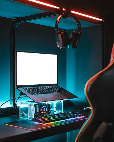 neon-lit-gaming-setup-laptop-mockup-on-stand-with-rgb-keyboard-and-modern-headset-display