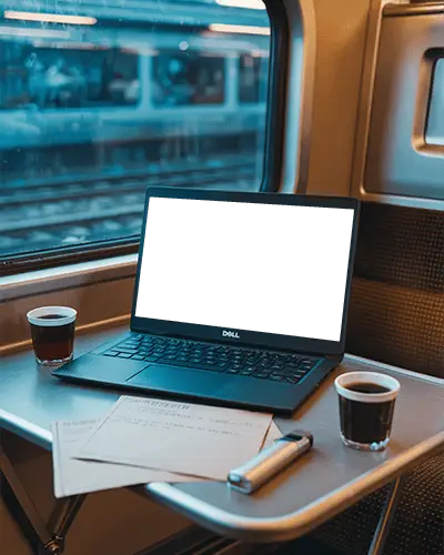 Dell Laptop Mockup On Train Table With Coffee Cups Documents And Window Track View