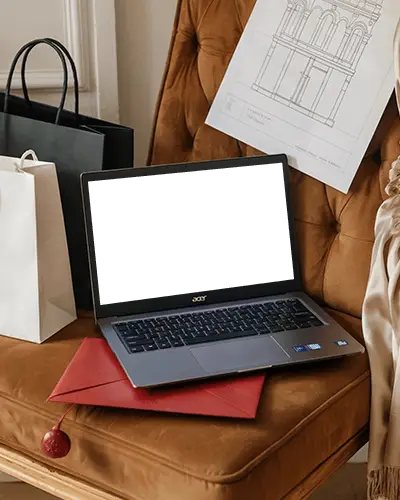 Acer Laptop Mockup On Velvet Chair With Shopping Bags Envelope And Architectural Drawing