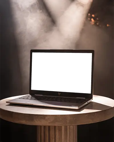hp-laptop-mockup-on-round-pedestal-table-with-dramatic-spotlight-and-smoky-background