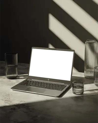 hp-laptop-mockup-on-marble-table-with-glassware-and-dramatic-sunlight-shadows