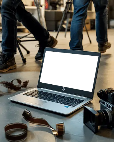 Modern Hp Laptop Mockup Digital Device On Floor With Film Rolls And Camera In Studio Setting