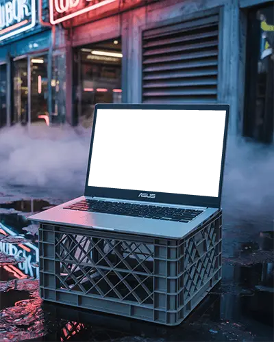 Asus Laptop Mockup On Crate In Urban Street Scene With Neon Signs And Misty Night Atmosphere