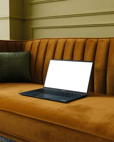Stylish Laptop Mockup On Upholstered Couch For Branding And Web Design Display