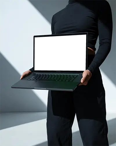 Razer Laptop Mockup Held By Person In Black Outfit With Strong Light Shadows In Minimal Studio Space
