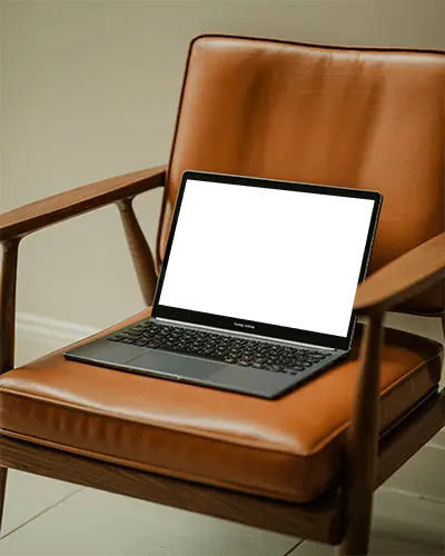 Samsung Laptop Mockup On Vintage Brown Leather Chair In Modern Home Office With Warm Natural Light