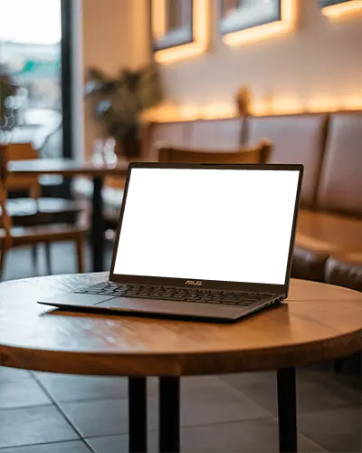 Asus Laptop Mockup On Wooden Cafe Table With Modern Interior And Cozy Lighting In Relaxed Setting