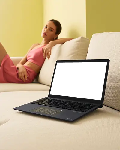 Asus Laptop Mockup On Sofa With Woman In Pink Outfit Relaxed Modern Home Interior With Soft Light
