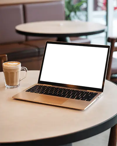 Microsoft Surface Laptop Mockup On Cafe Table With Coffee Cup In Cozy Modern Coffee Shop Environment