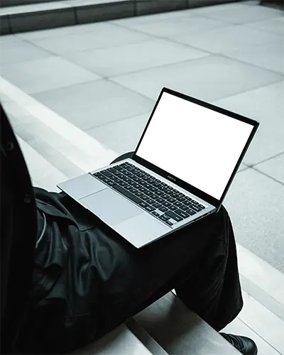 Asus Laptop Mockup On Persons Lap In Modern Urban Environment With Minimal Grey Stone Background
