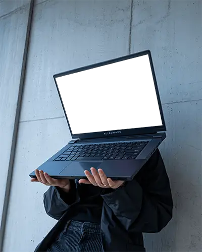 Alienware Gaming Laptop Mockup Held Up By Person In Modern Minimal Setting With Concrete Wall