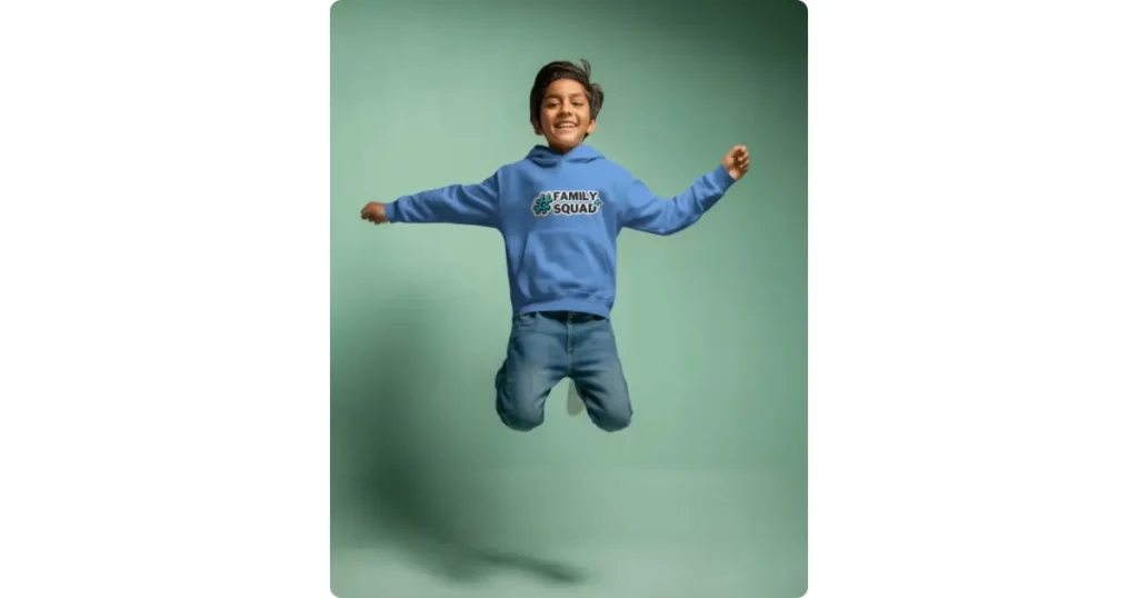 boy in a hoodie jumping and smiling