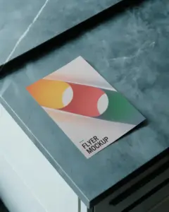 dark marble textured flyer mockup on polished surface with sleek light reflection