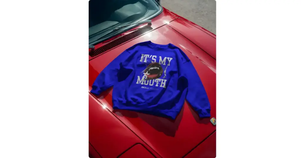 a blue sweatshirt lies on a red car