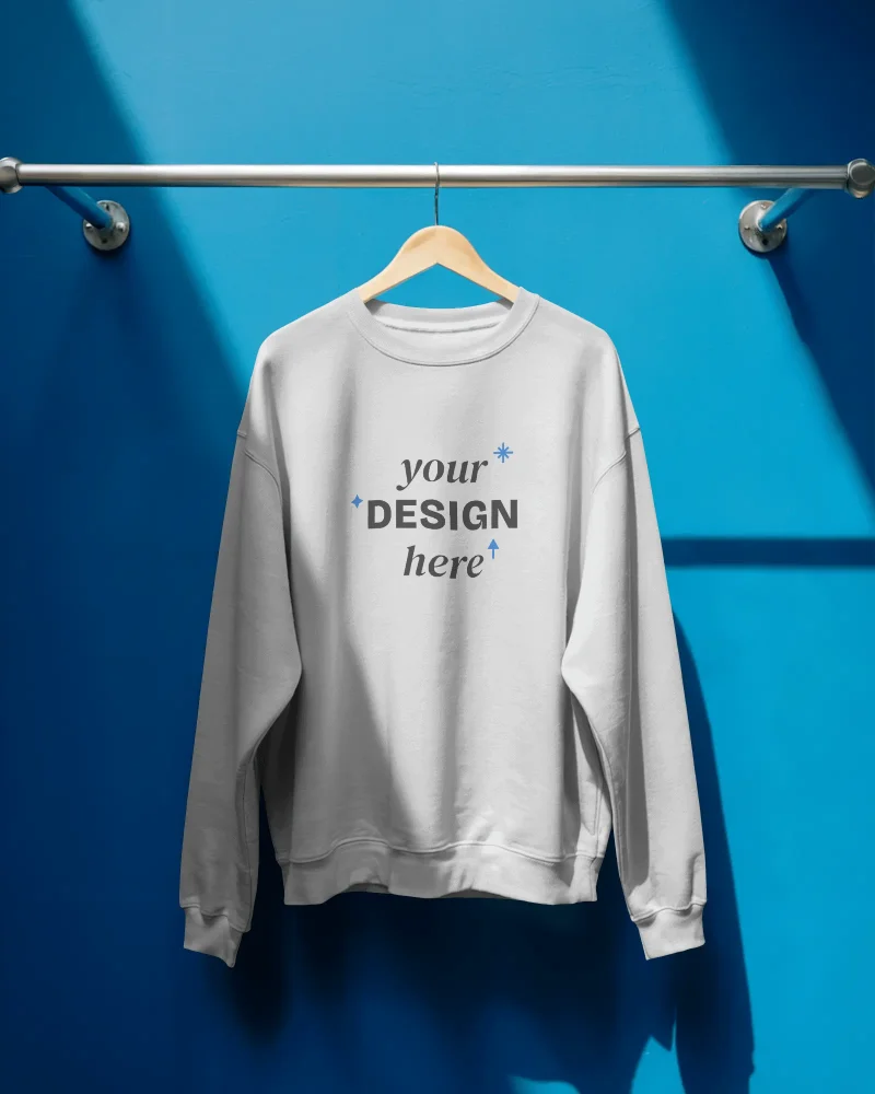 hanging sweatshirt mockup on wooden hanger blue wall bright clean display retail fashion
